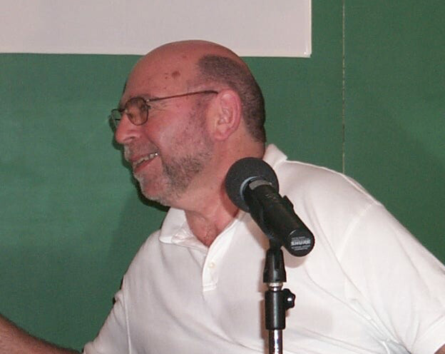 A candid shot of poet and scientist Charles Levenstein, Ph.D., M.S.O.H, while lecturing.